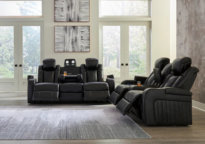 A cozy living room scene centered around a luxurious leather power reclining sofa, with warm ambient lighting and modern decor elements reflecting a southeastern U.S. aesthetic.